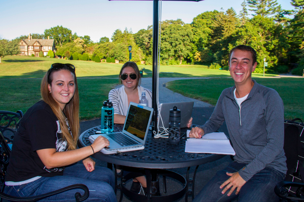 Students at one of the new tables outside of Humanities Hall.