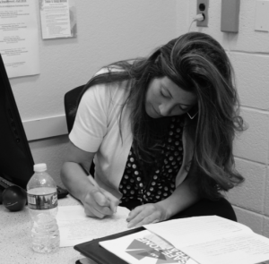 Photo by: Adela Ramos  Nurse Jacquelyn making jot-downs at her office desk. 