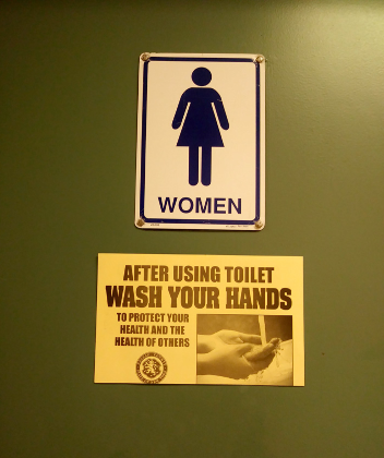 A poster reminding students to was their hands appeared on bathroom doors in residence halls